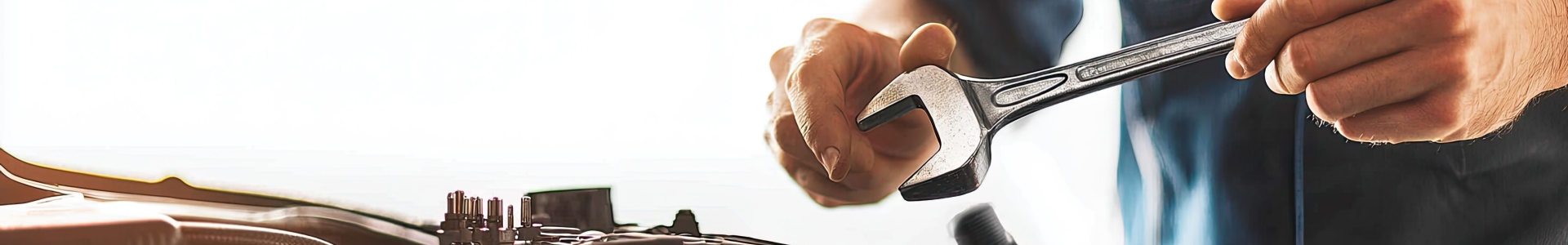 Up close view of someone working on a car. 