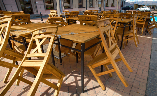 Restaurant patio chairs locked to table. Photo courtesy of Tricky Shark, Stock.Adobe.com.