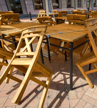 Restaurant patio chairs locked to table. Photo courtesy of Tricky Shark, Stock.Adobe.com.