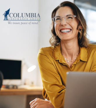 Woman with laptop smiling.